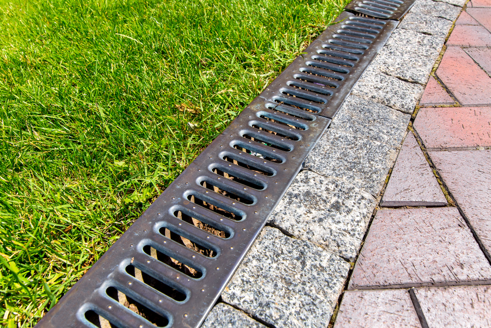 French drain between grass and pathway